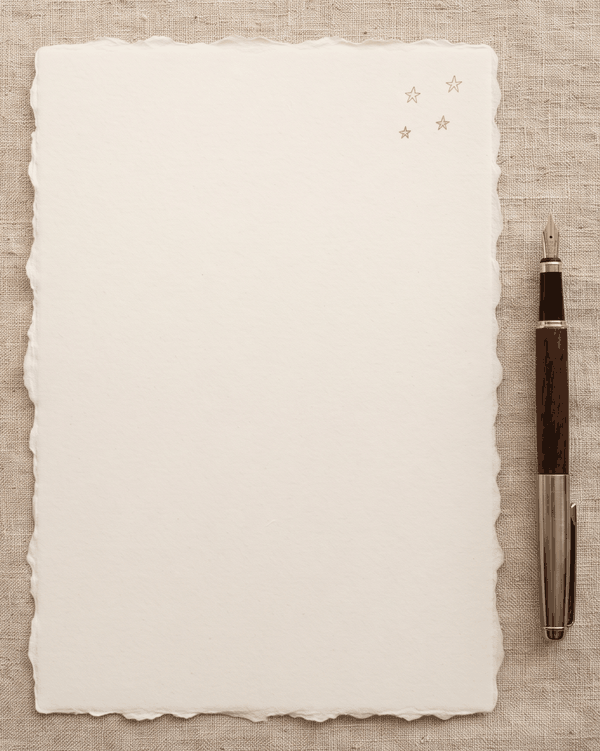 A sample letter written on cream paper with small gold stars
